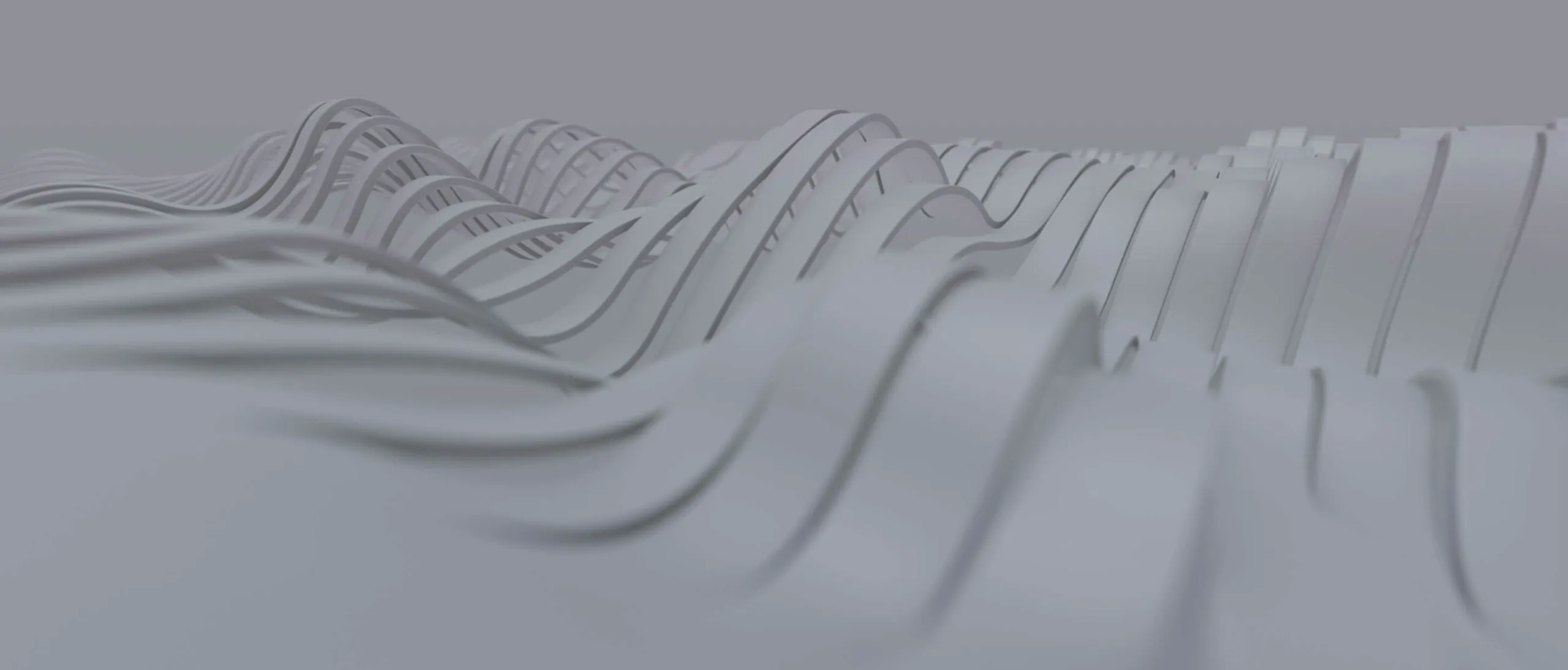 Abstract close-up of multiple smooth, curved gray ribbons or bands flowing and overlapping horizontally.