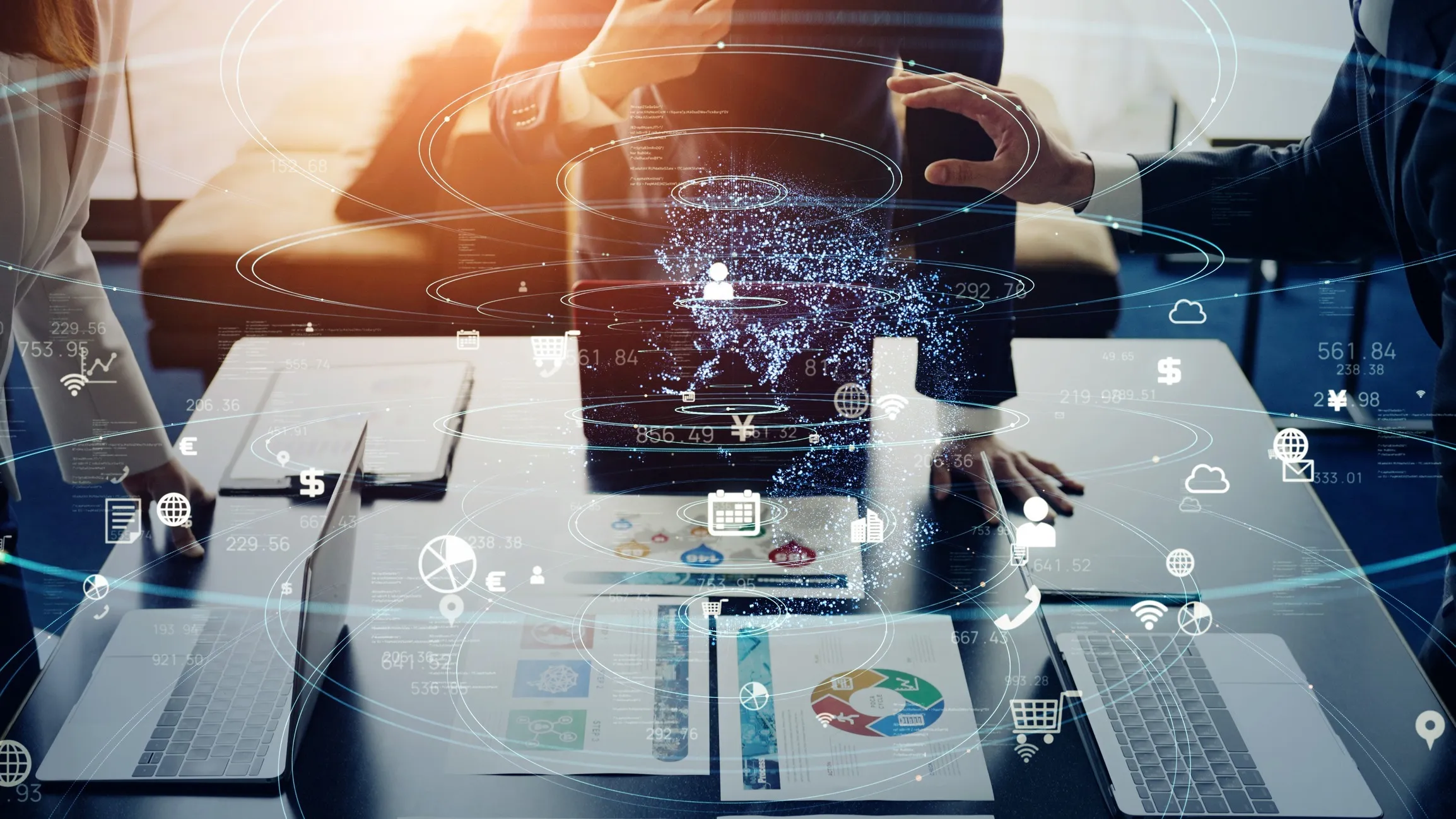 Businesspeople standing around a table with laptops and charts, overlaid with a digital globe and various technology and data icons representing global connectivity and data exchange.