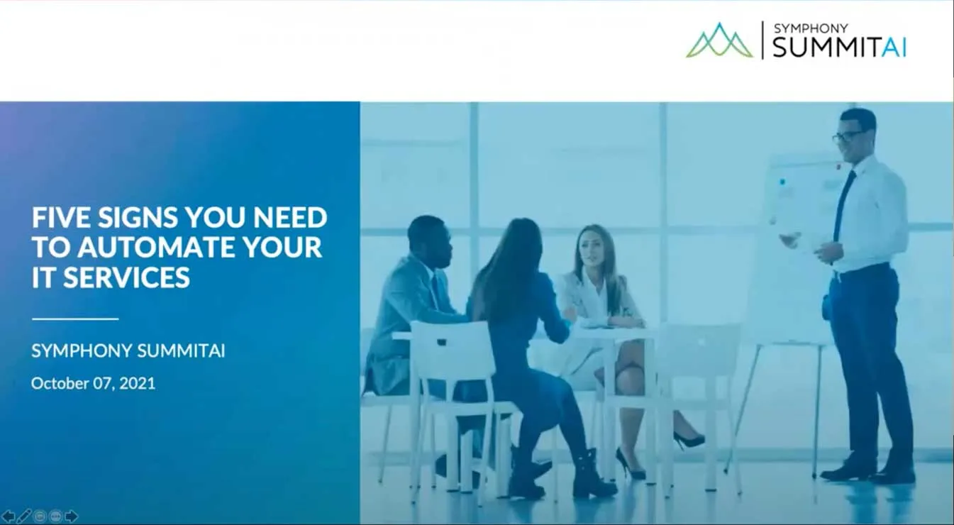 Presentation slide titled 'Five Signs You Need to Automate Your IT Services' by Symphony SummitAI dated October 07, 2021, showing a man standing and presenting to three seated professionals in a bright office.