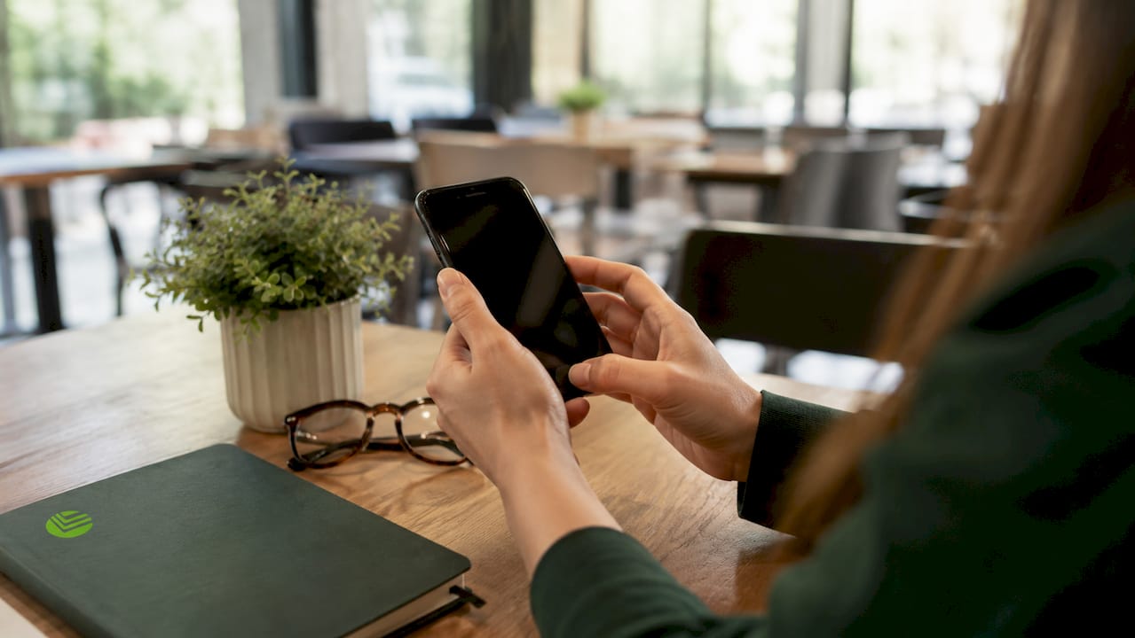 Hands holding smartphone for telehealth
