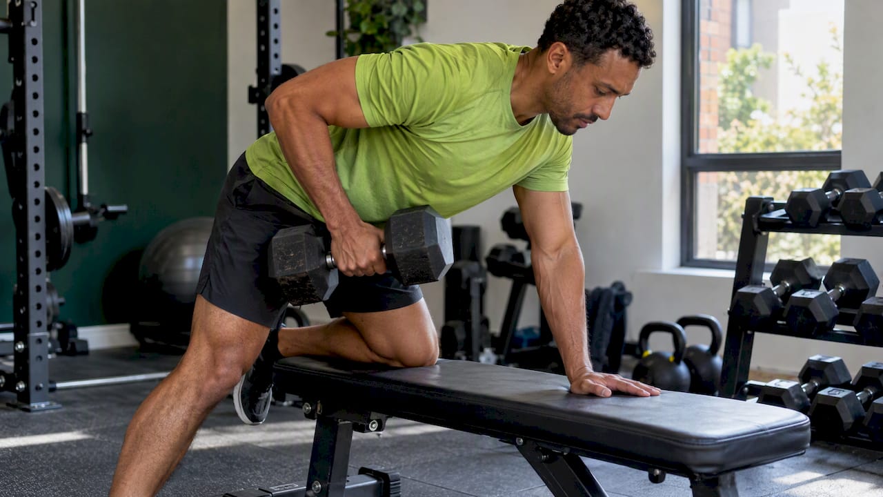Man doing a dumbbell row during strength training
