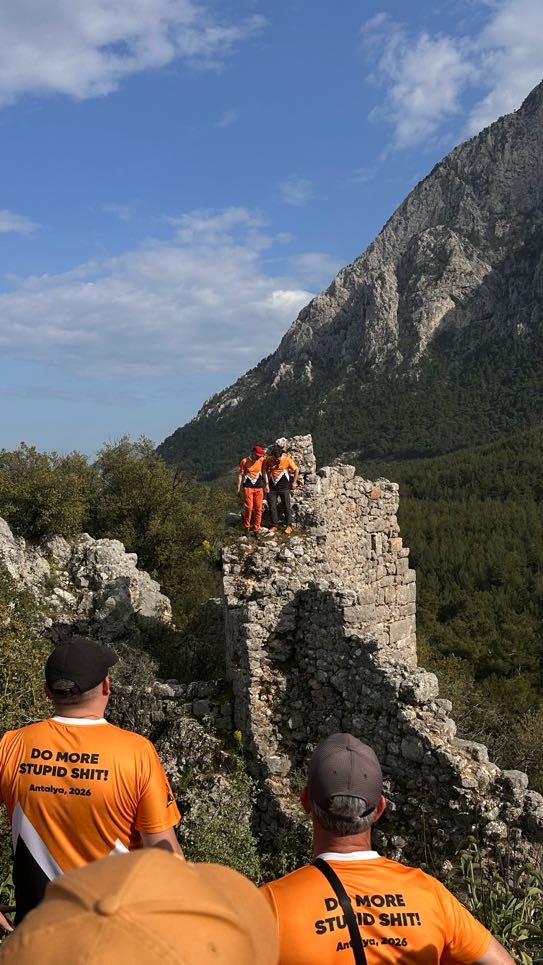 Small group of Percona team members ascending an additional peak after the Trebenna hike, late afternoon light