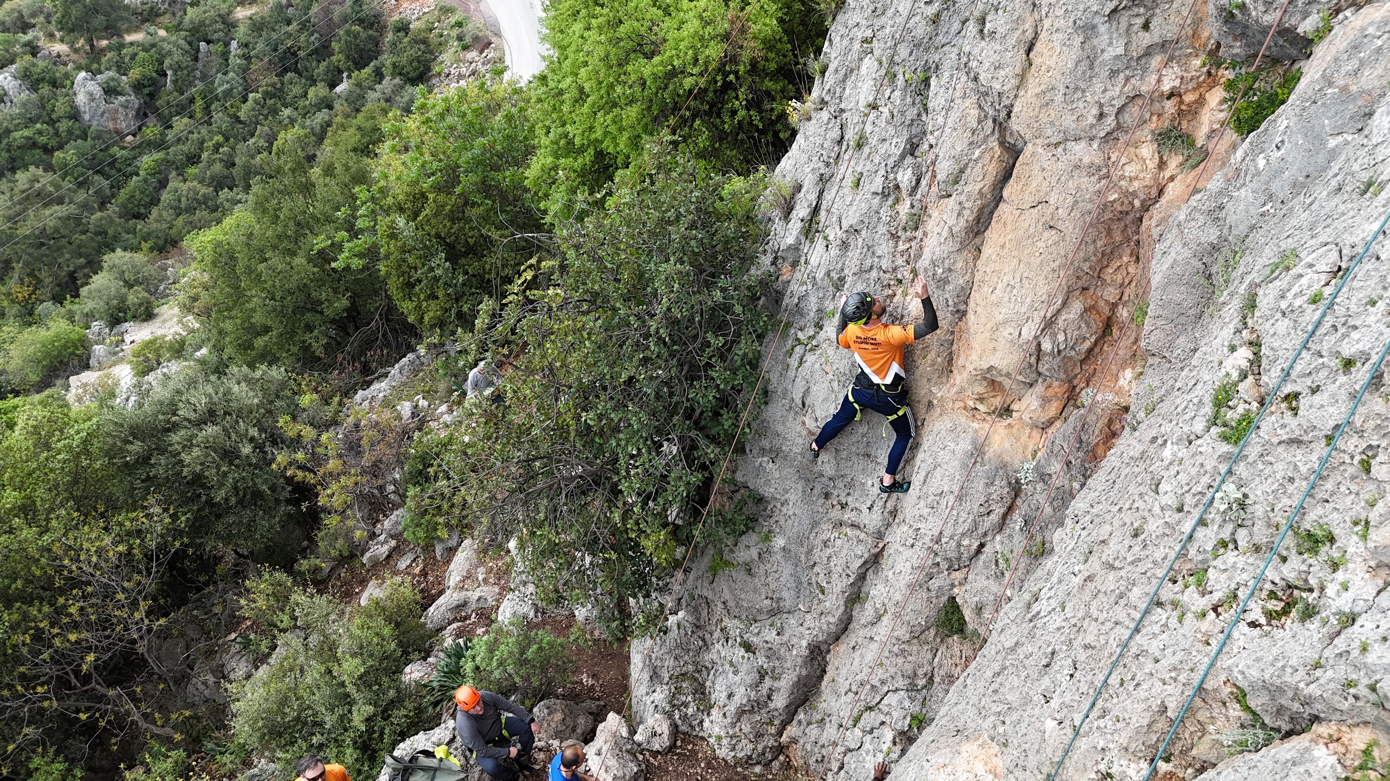 Another Percona team member on a different limestone route, smiling mid-climb at Geyikbayiri