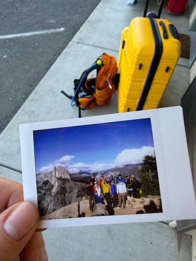 A polaroid photo from the Yosemite trip resting against travel luggage