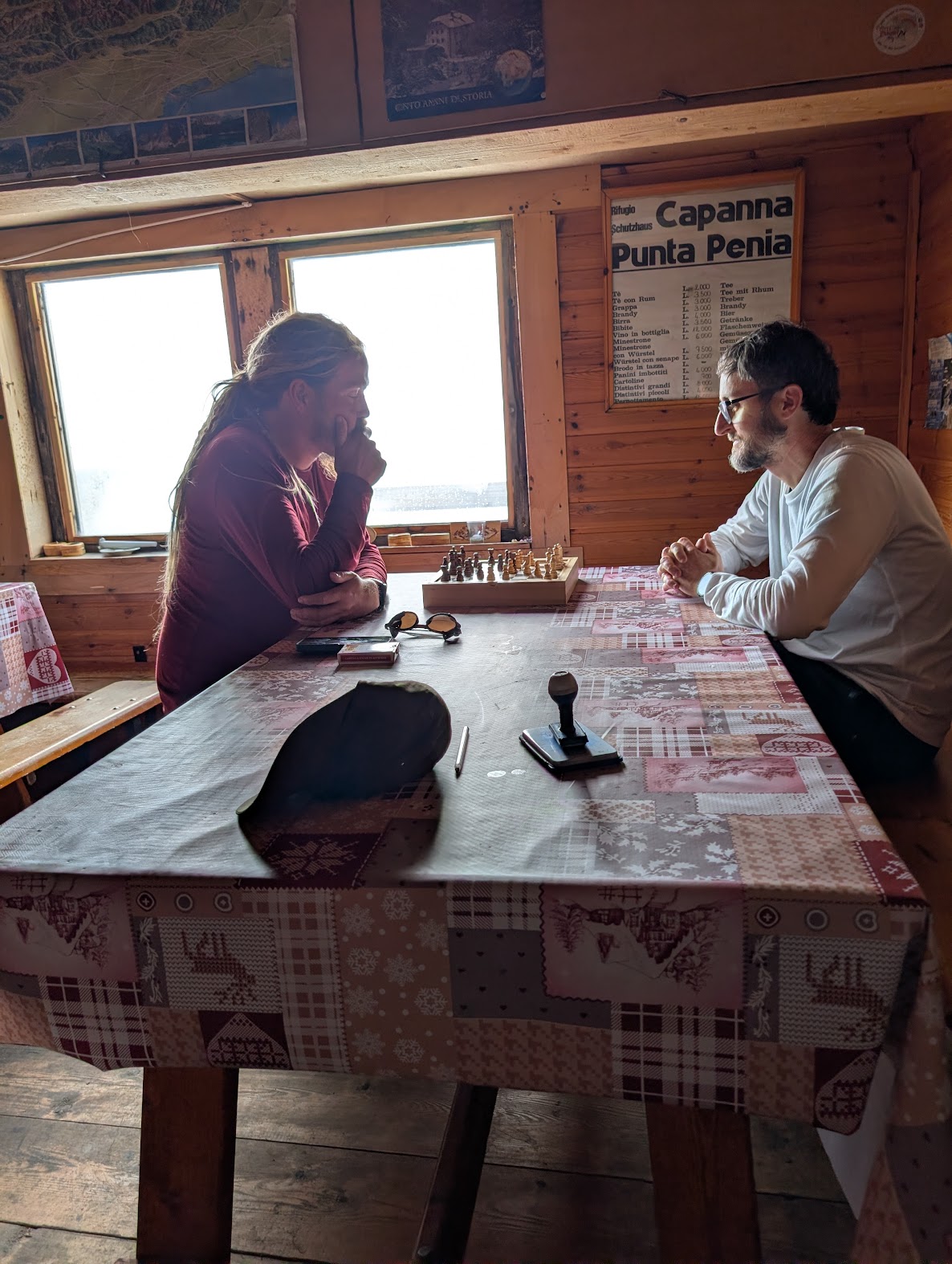 Playing chess inside the summit hut on Marmolada
