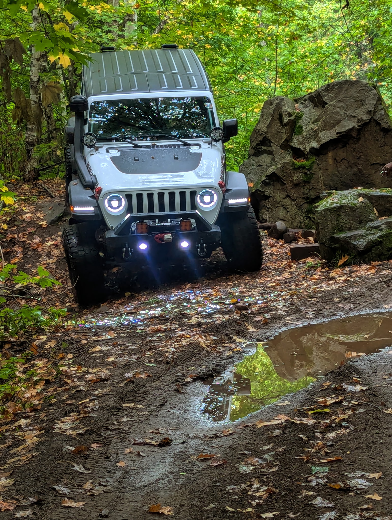 A jeep making it's way through rocky terrain.