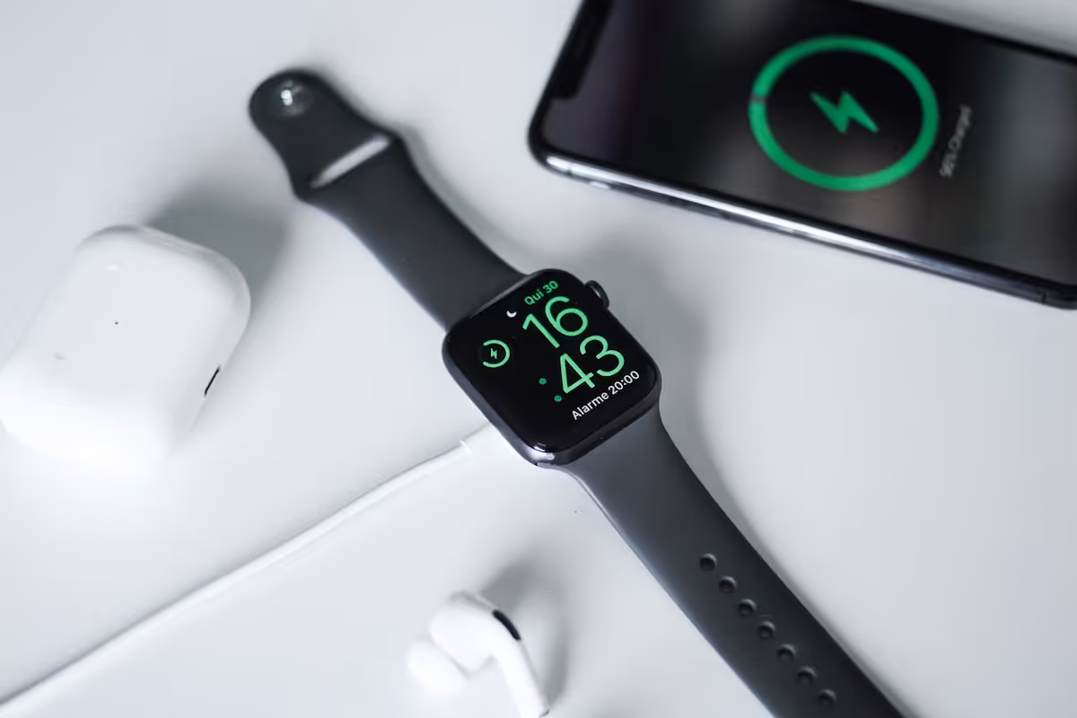 a smart watch with a charger and earphones
