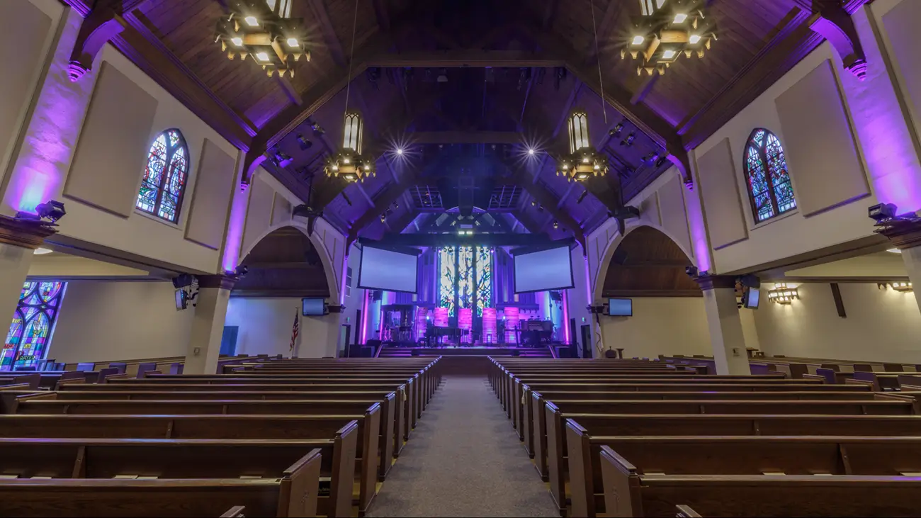 Clean carpet running down the center aisle of a Yakima church sanctuary between rows of pews