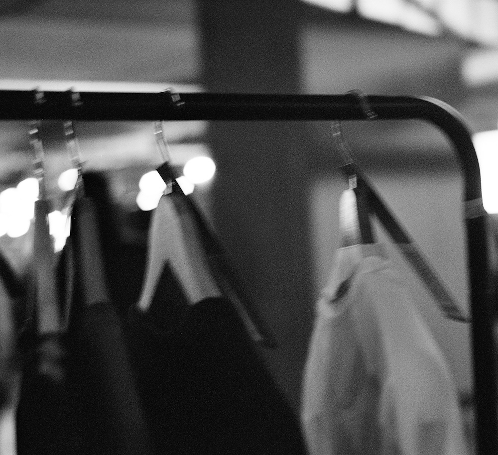 Abstract background with warm orange and dark brown light streaks and subtle golden sparkles.