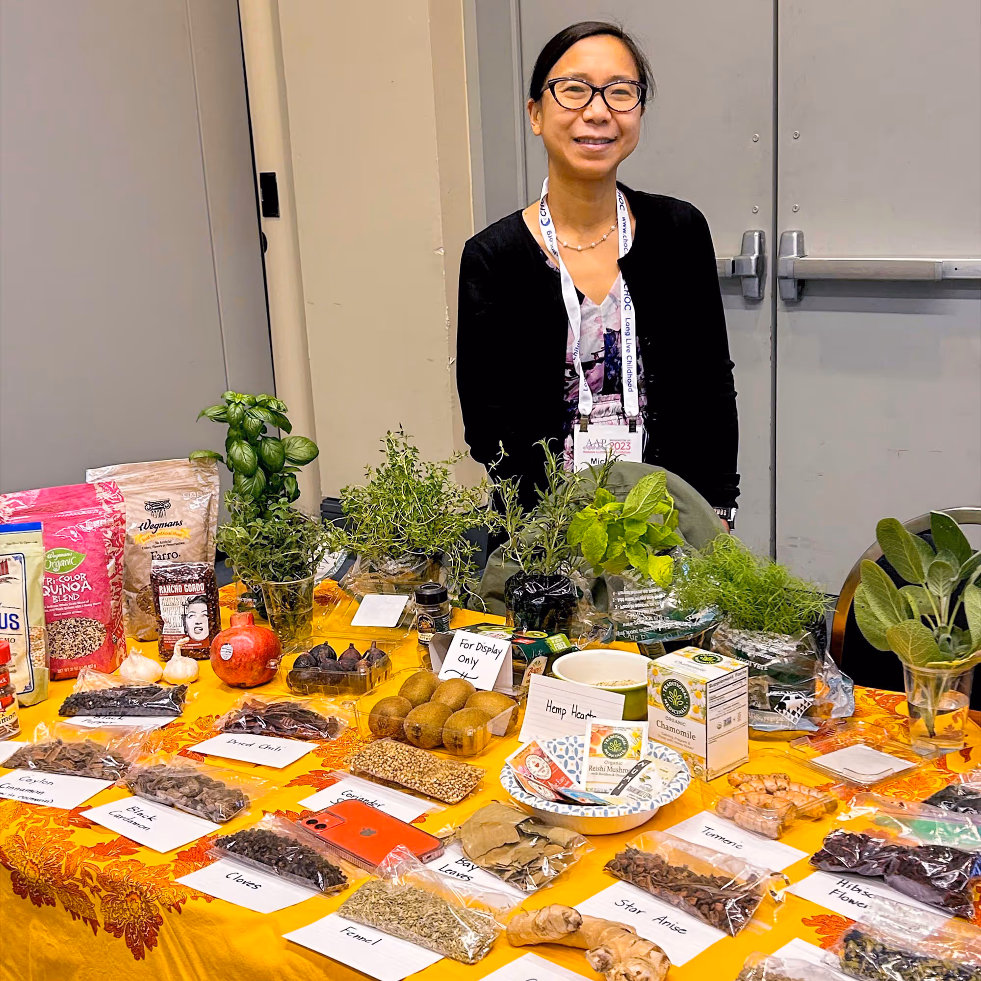 Culinary medicine demonstration table with fresh herbs at an American Academy of Pediatrics event