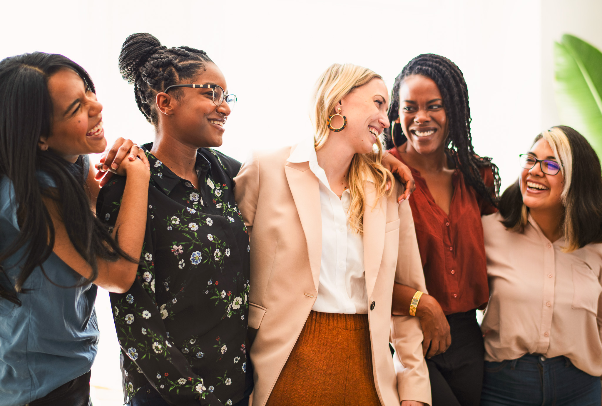 A group of diverse women laughing and sharing a happy moment