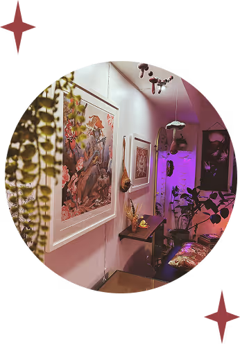 Cozy corner with framed fantasy art on walls, hanging plants, a small shelf with dried flowers, and purple grow lights illuminating indoor plants.
