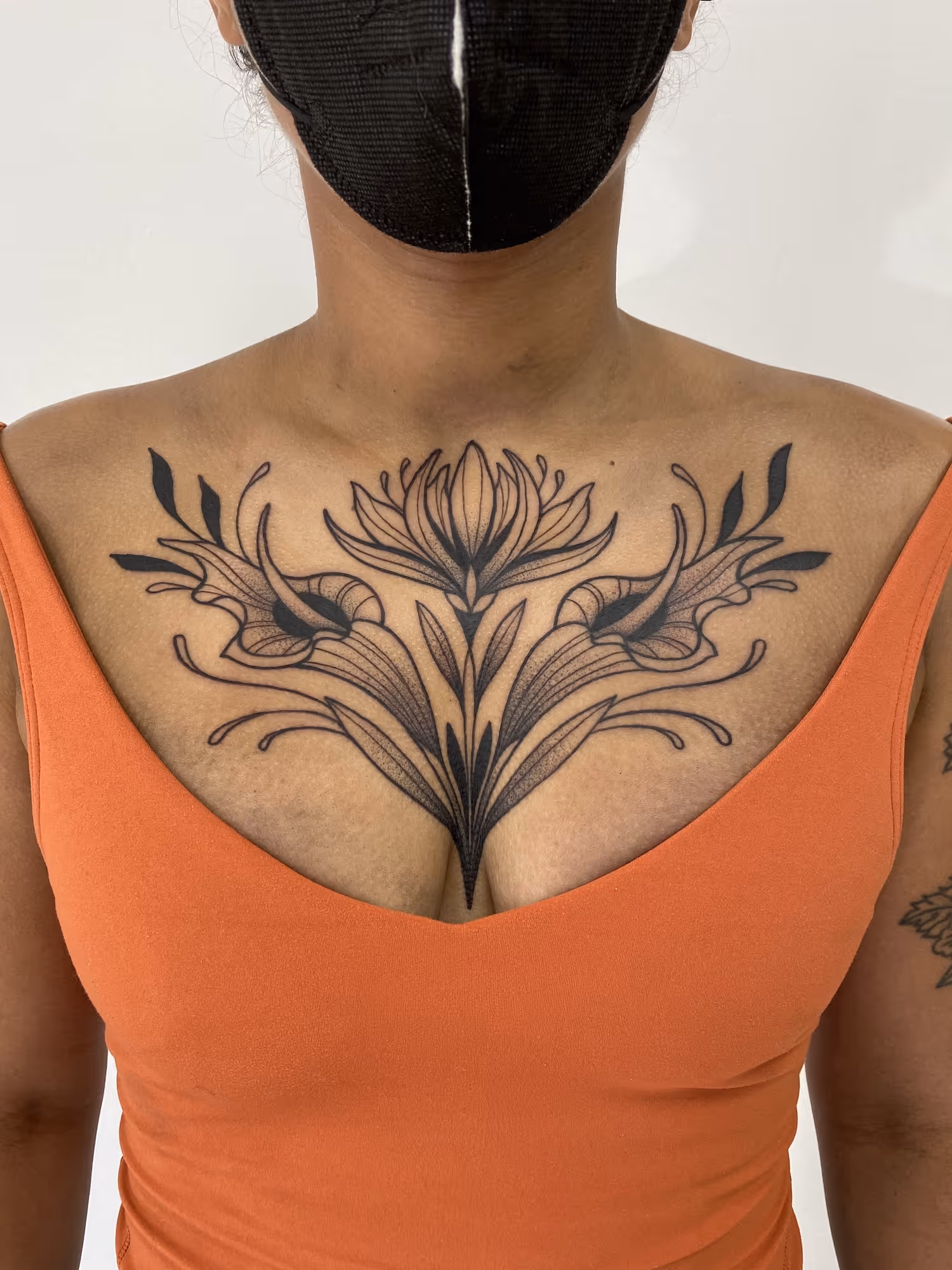 Illustrative blackwork floral chest tattoo with stylized flowers and leaves, by Alyssa at Vale of the Fae in Castlegar, BC