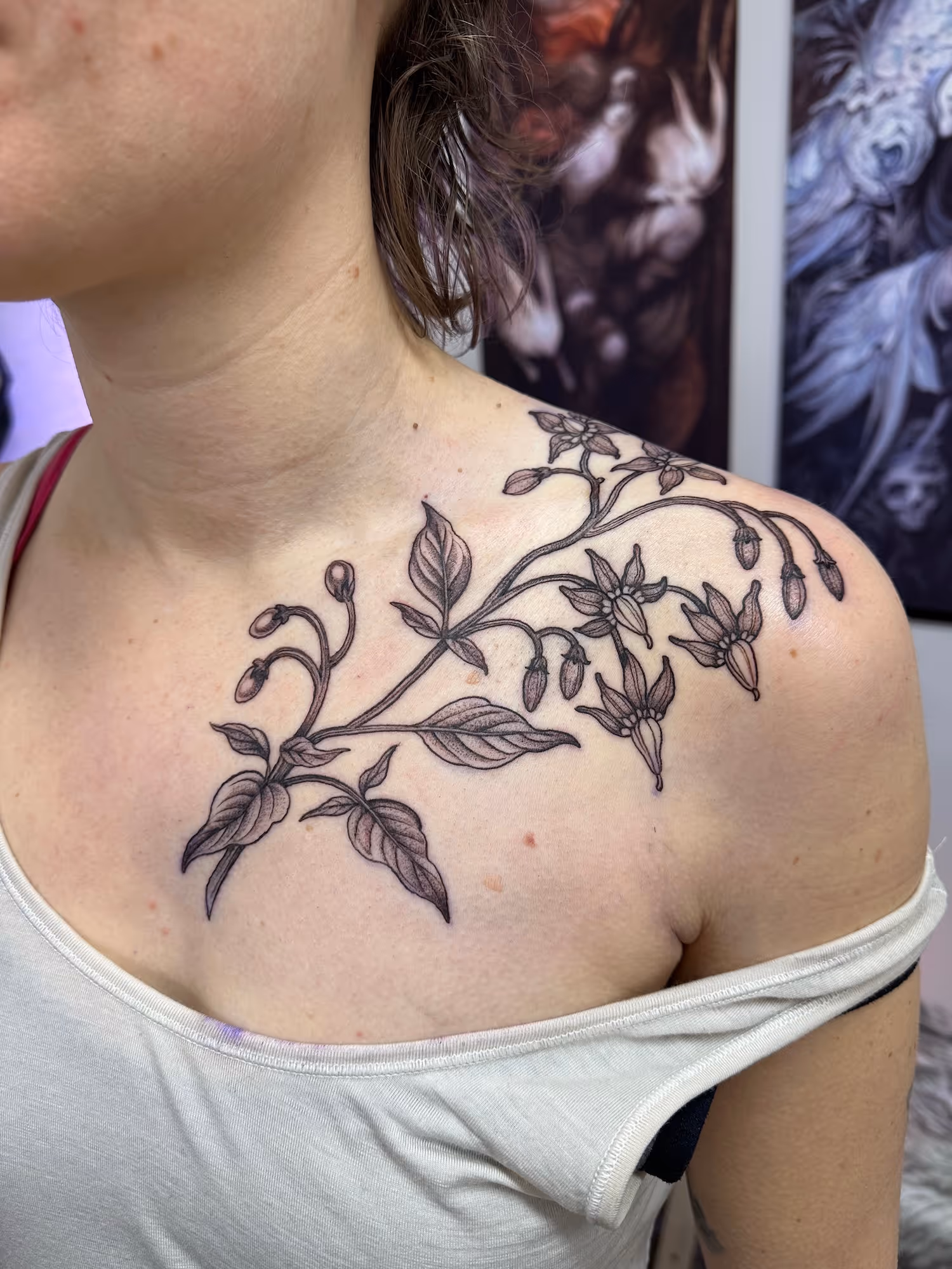 Blackwork bramble tattoo of a flowering botanical branch on the upper chest and shoulder, by Alyssa at Vale of the Fae in Castlegar, BC