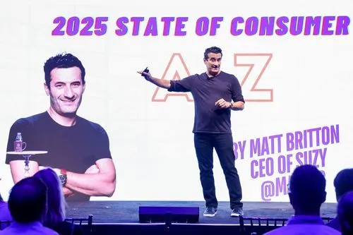 Matt Britton, CEO of Suzy, speaking on stage with a presentation slide behind him titled '2025 State of Consumer A to Z'.