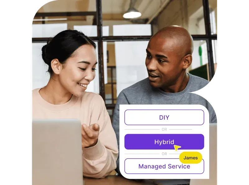 A smiling woman and man sitting together with laptops, discussing while selecting 'Hybrid' from options including DIY and Managed Service.