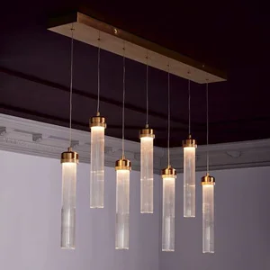 Row of cylindrical pendant lights with textured glass diffusers