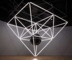 Cube frame of linear light tubes suspended around a dark sphere