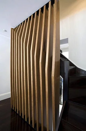 Timber fin screen separating a stair hall from the adjoining room
