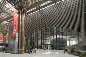 Atrium lined with vertical timber slats running across ceiling and columns