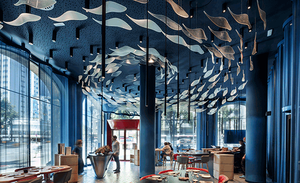 Restaurant ceiling hung with rows of blue fish-shaped panels