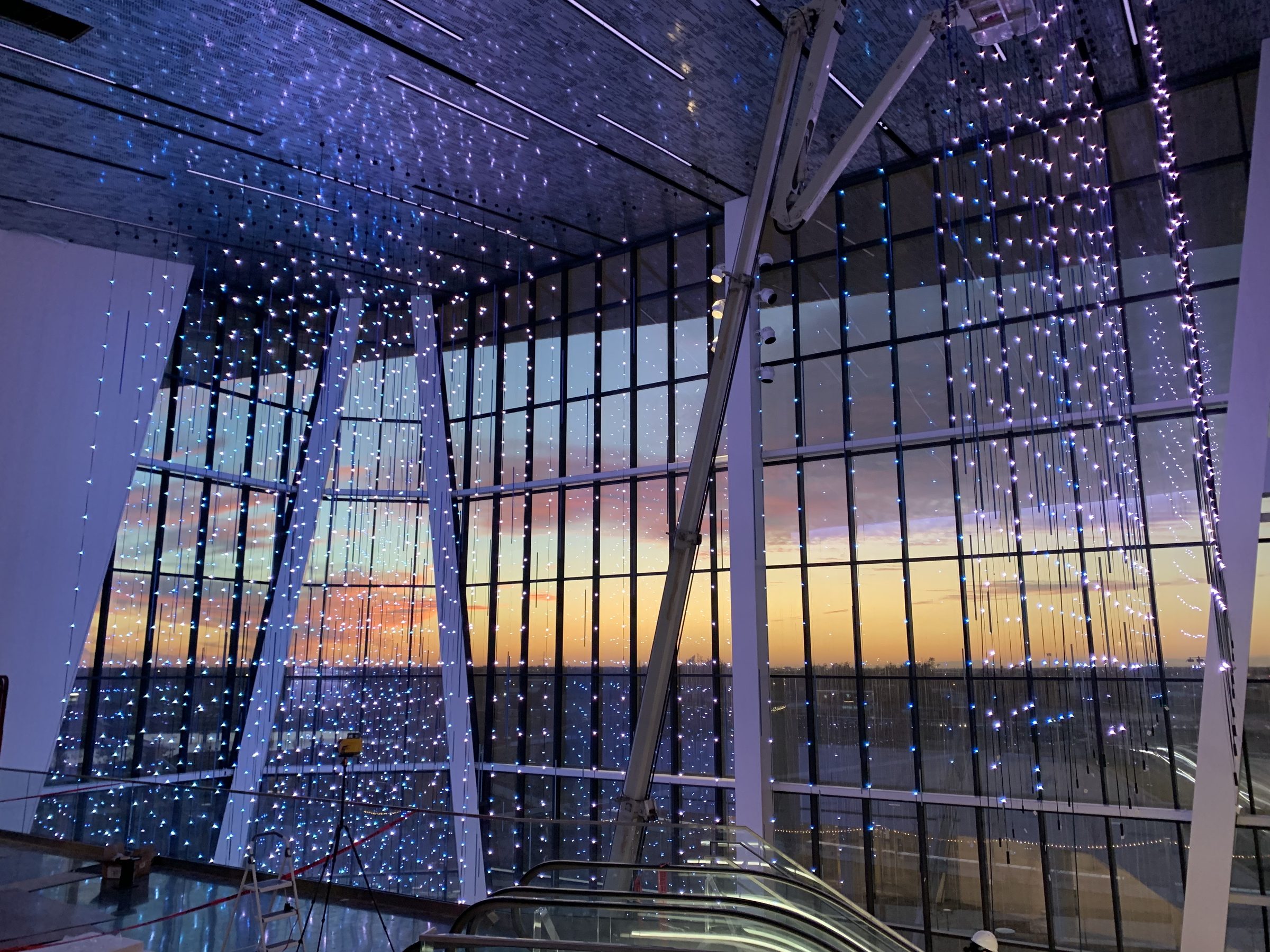 The Virtual Sky LED strands over the window wall at sunset above the staircase