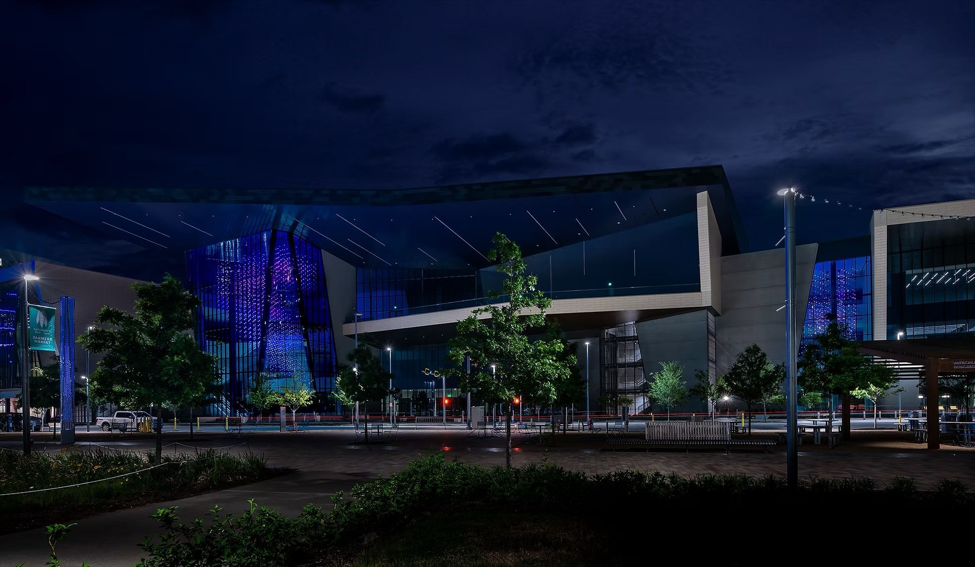 Night view of the convention centre with Virtual Sky lit blue across the glass corner