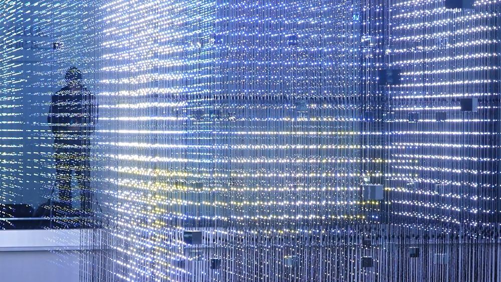 Close view of the Hypercube LED strand grid with the building beyond