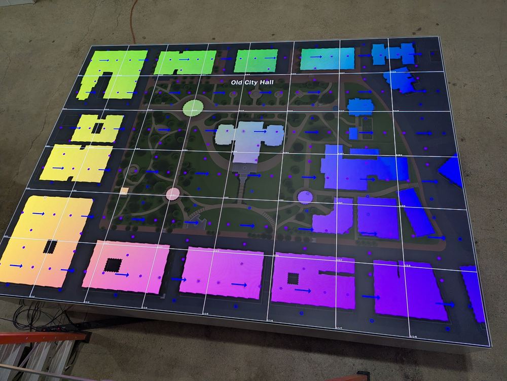 The Capitol table lit with mapped colour zones marking each building on the grounds