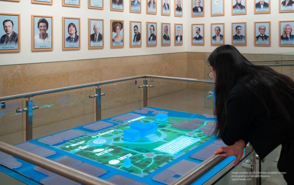Visitor leaning over the interactive LED table at the Virginia State Capitol