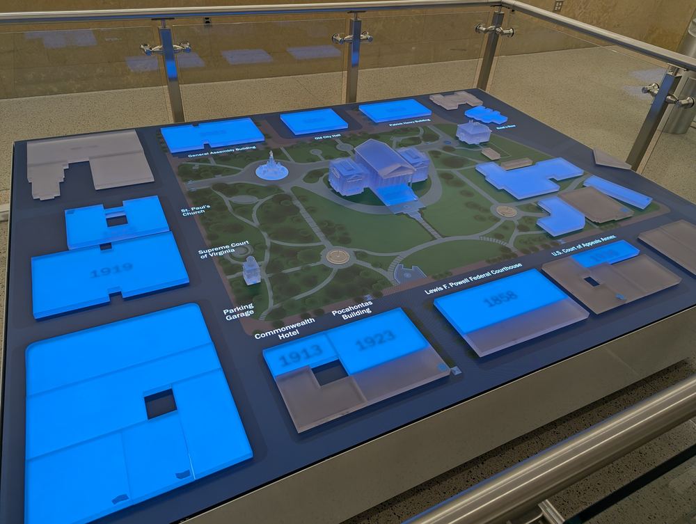 The Capitol table lit blue with building names and dates labelled across the map