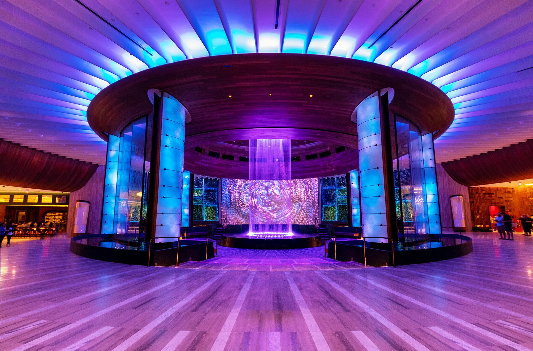The Hard Rock Oculus lobby lit blue, backlit columns framing the central feature