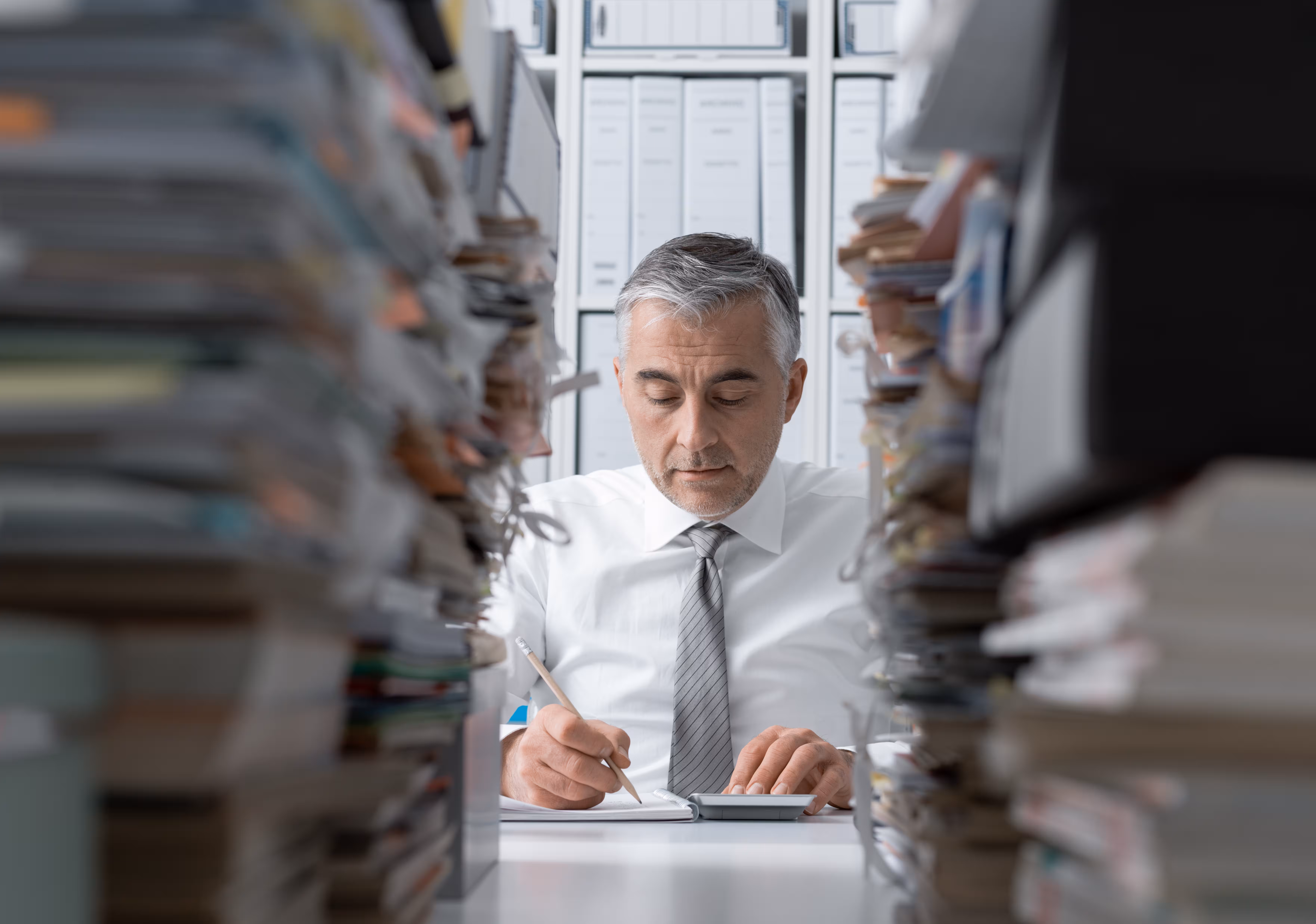 Man working with papers with an office setting