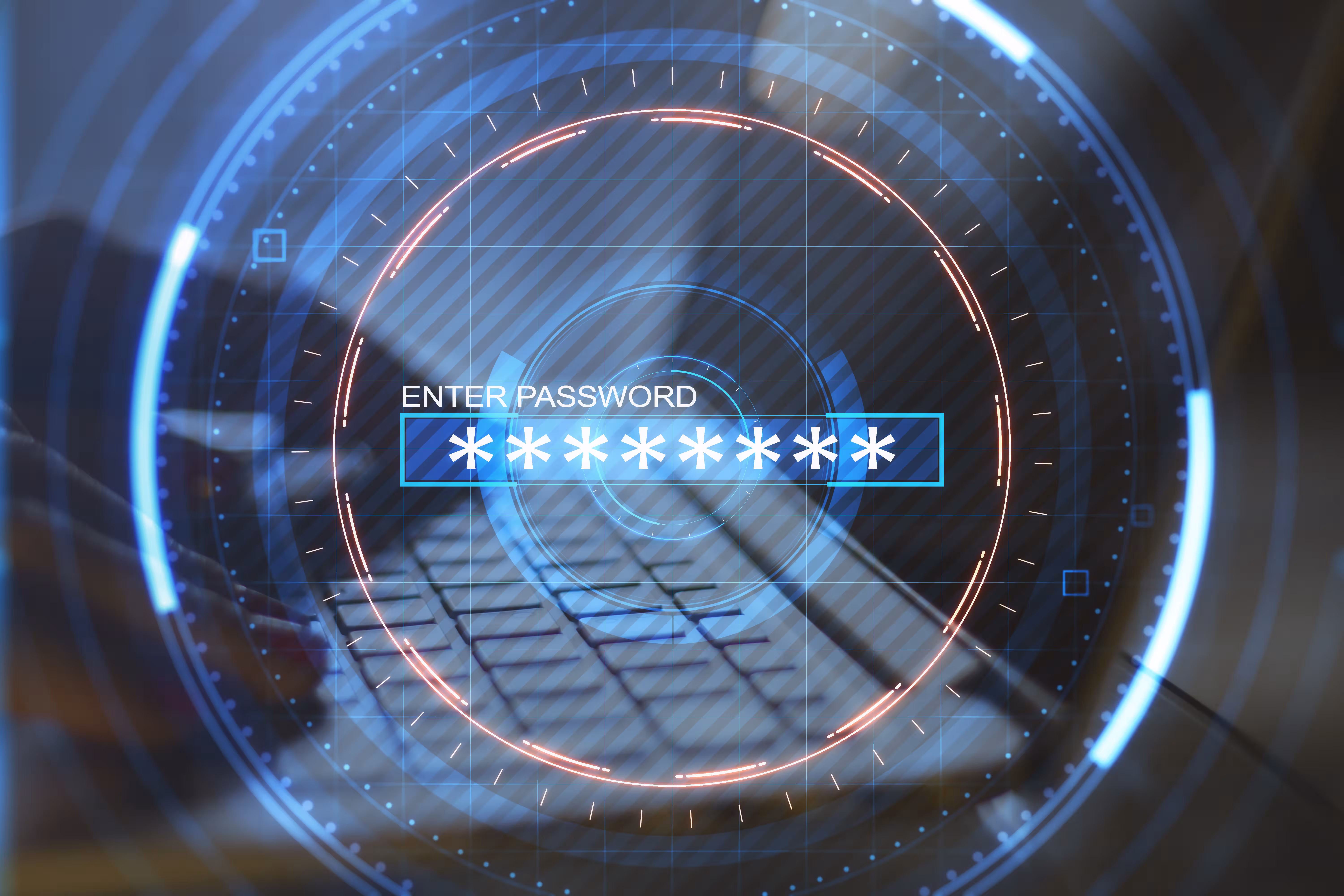 Hands on laptop entering a password. 