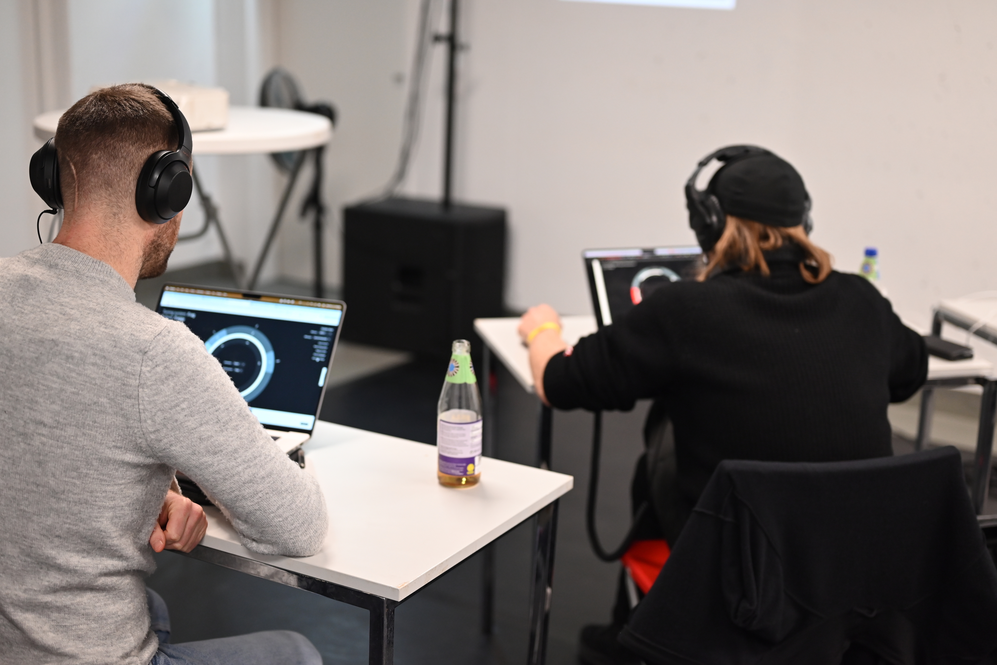Two participants with headphones working on Apotome in Ableton Live