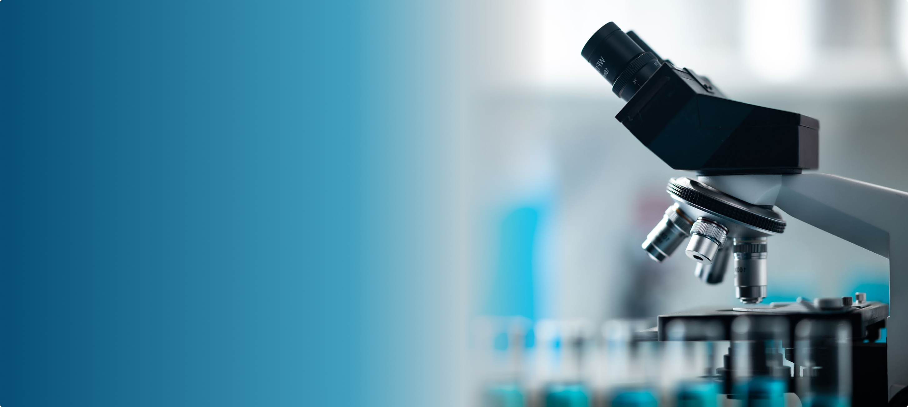 Laboratory microscope head and turret in soft focus beside a teal gradient background panel