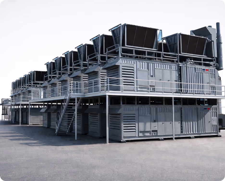 Two workers wearing yellow safety vests with Rolls-Royce SMR branding walk past a large industrial white cylindrical container inside a factory.