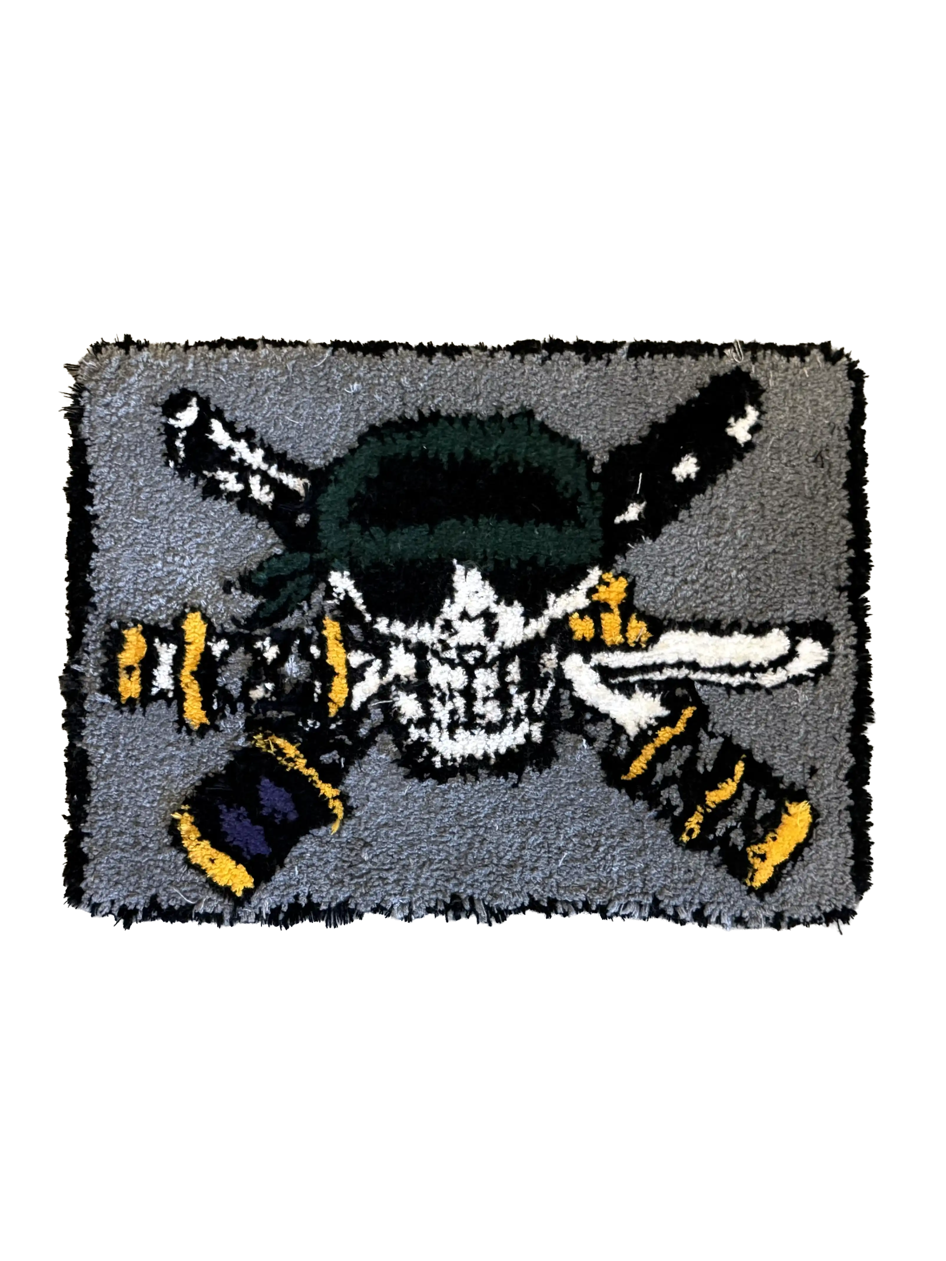 Custom rug featuring a skull with a green bandana and crossed items, on a grey background