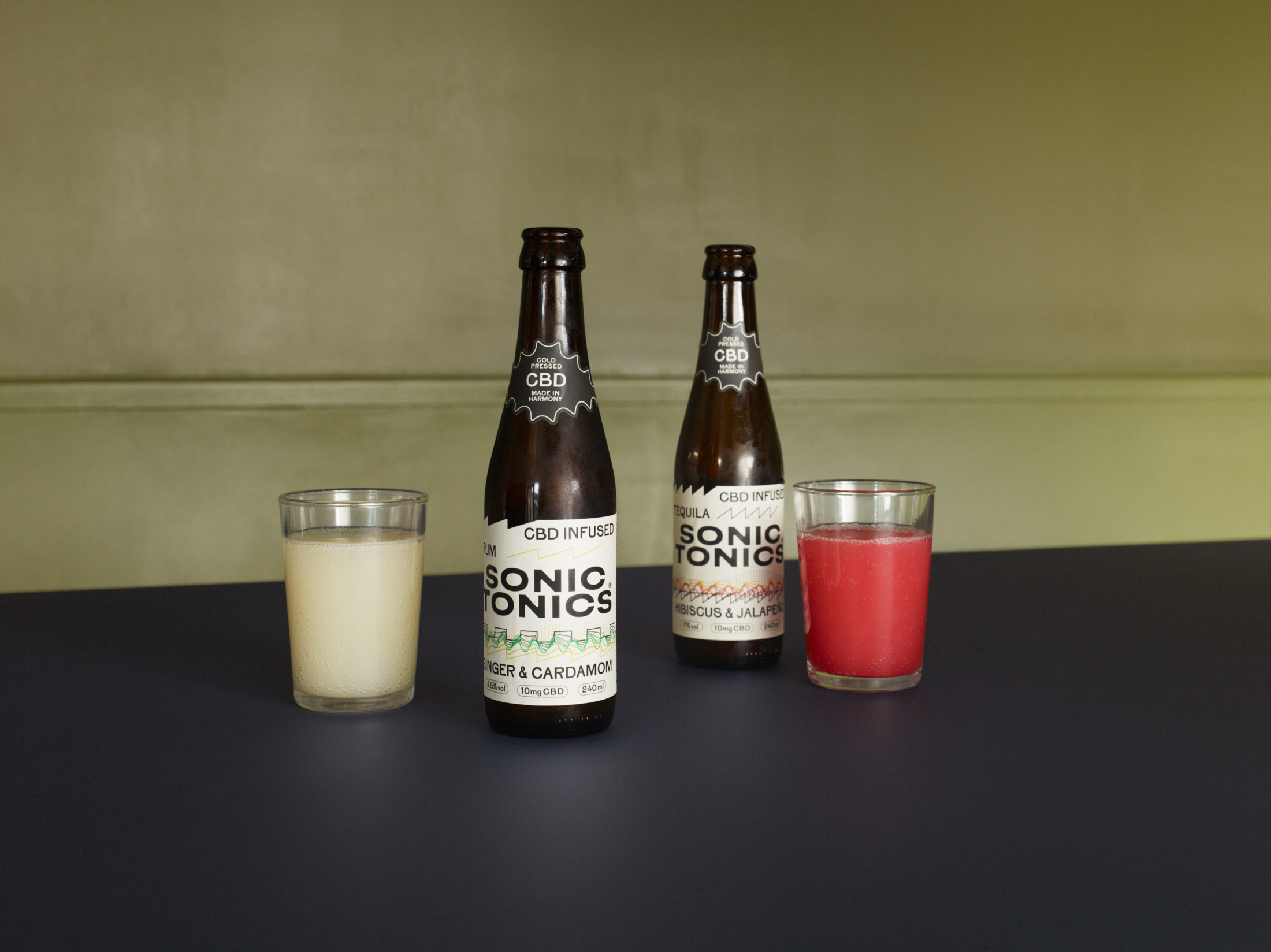 Sonic Tonics Ginger and Cardamom and Hibiscus and Jalapeño drinks served chilled beside their bottles
