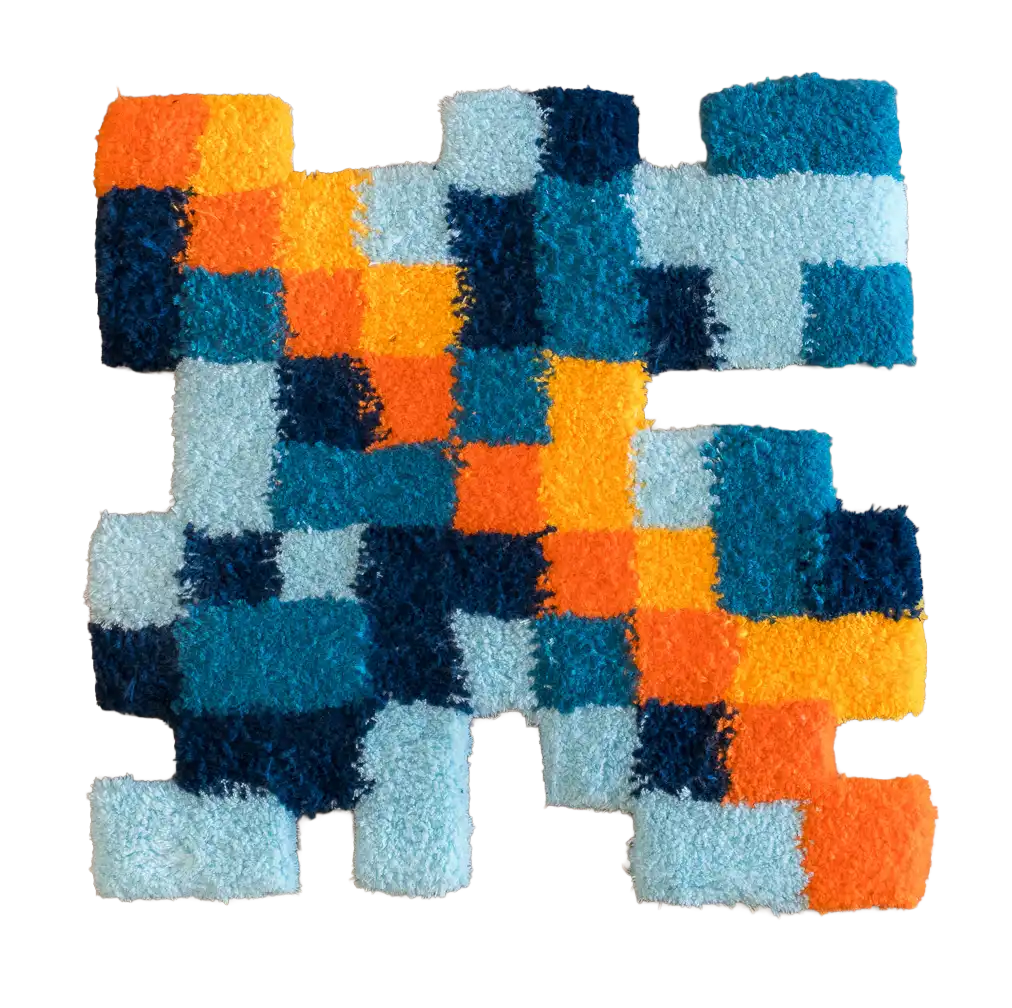 Abstract pixel-style tufted rug in orange, yellow and multiple shades of blue