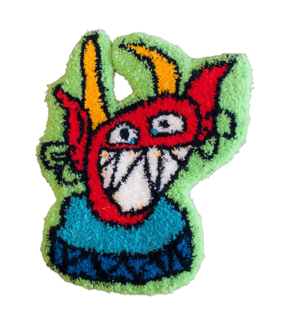 Light green character-shaped tufted rug featuring a red grinning creature with long yellow ears