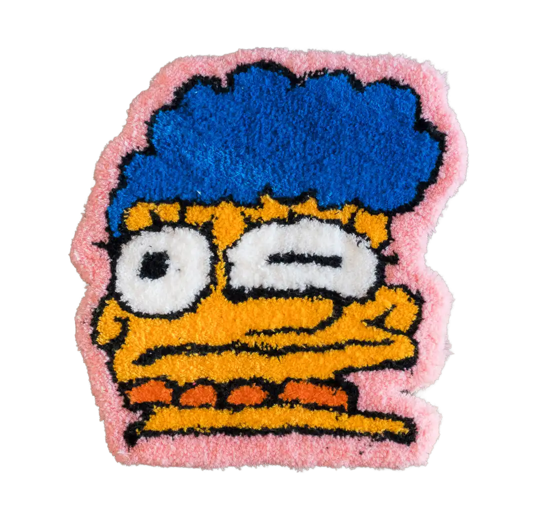Winking blue-haired cartoon face tufted rug with orange skin, white eyes and a pale pink border