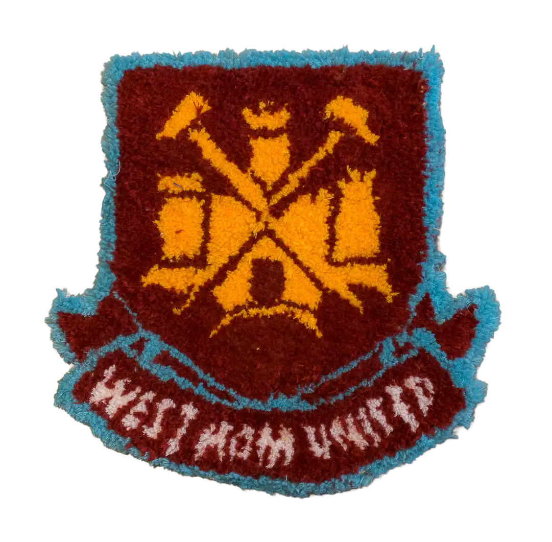 Burgundy and blue football crest tufted rug with crossed hammers and a ribbon banner