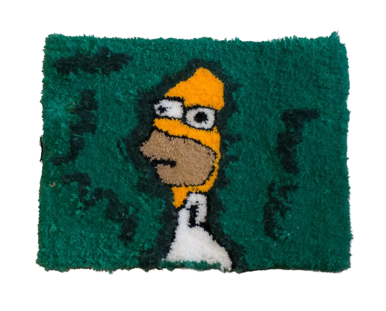 Green rectangular tufted rug featuring a yellow cartoon man in a white shirt and dark green patterns