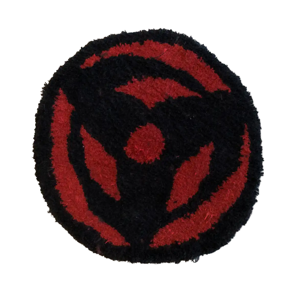 Round black tufted rug with a bold red circular eye-style emblem
