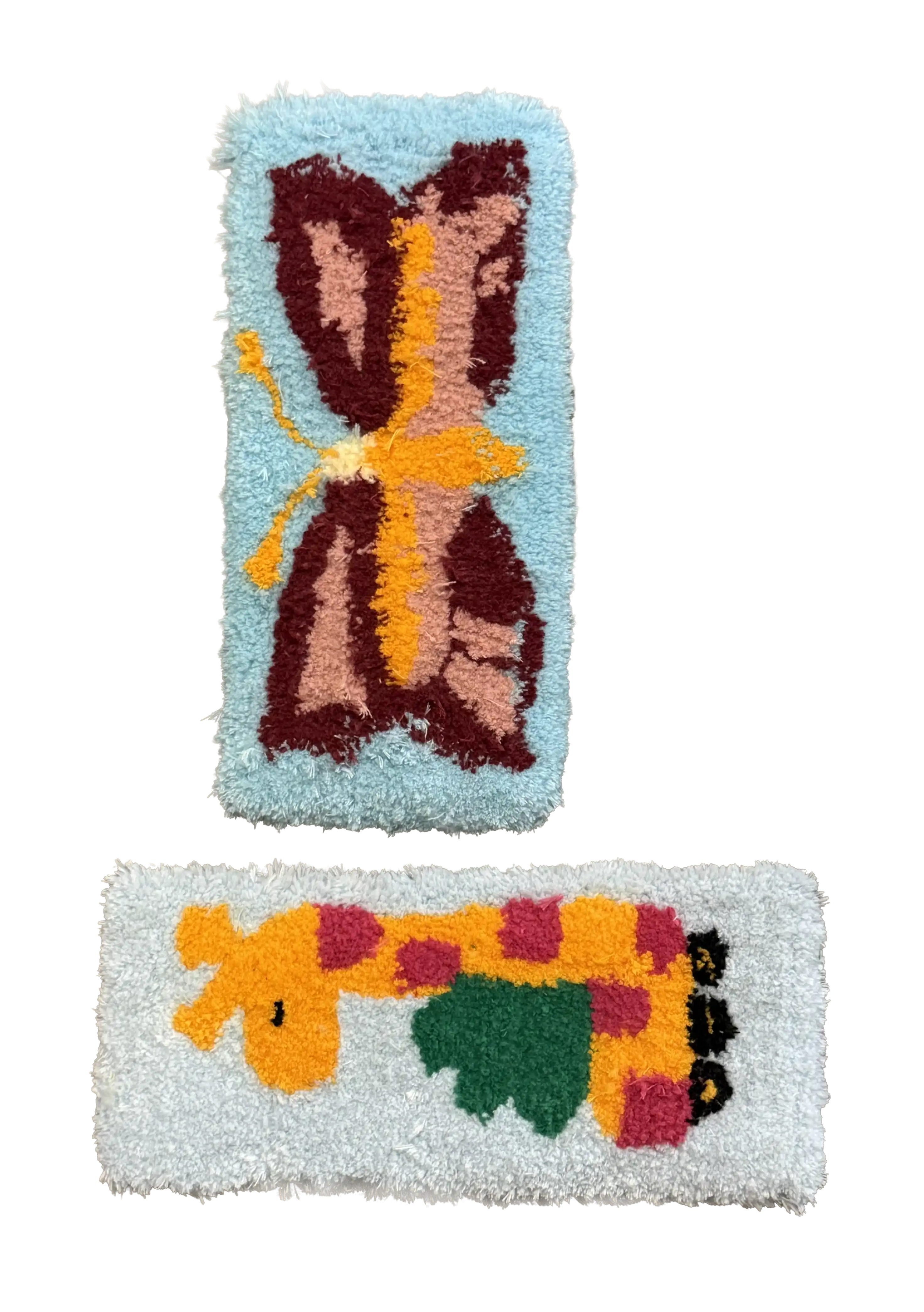 Two customer-made tufted rugs featuring a butterfly and a colourful giraffe