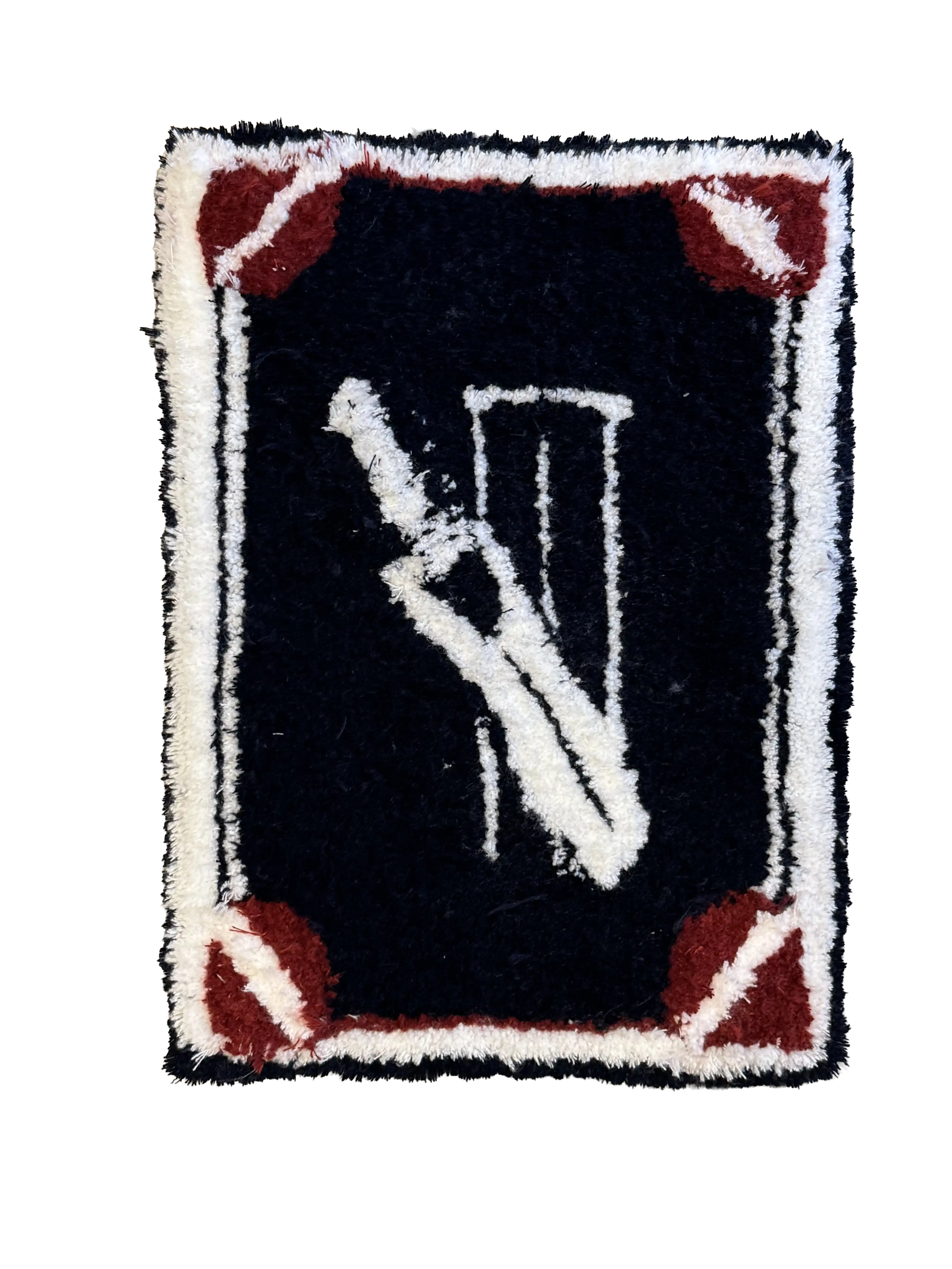 Black rectangular tufted rug designed like a playing card with a white peace-sign hand