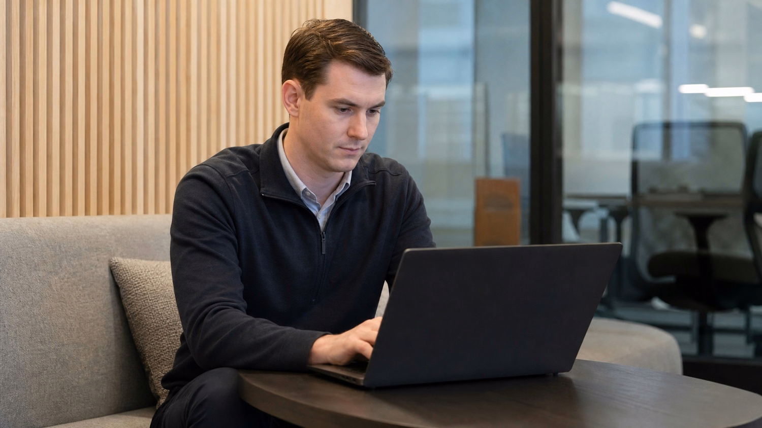 LOUNGE AREA LAPTOP An IT professional one person working on a laptop in a ca