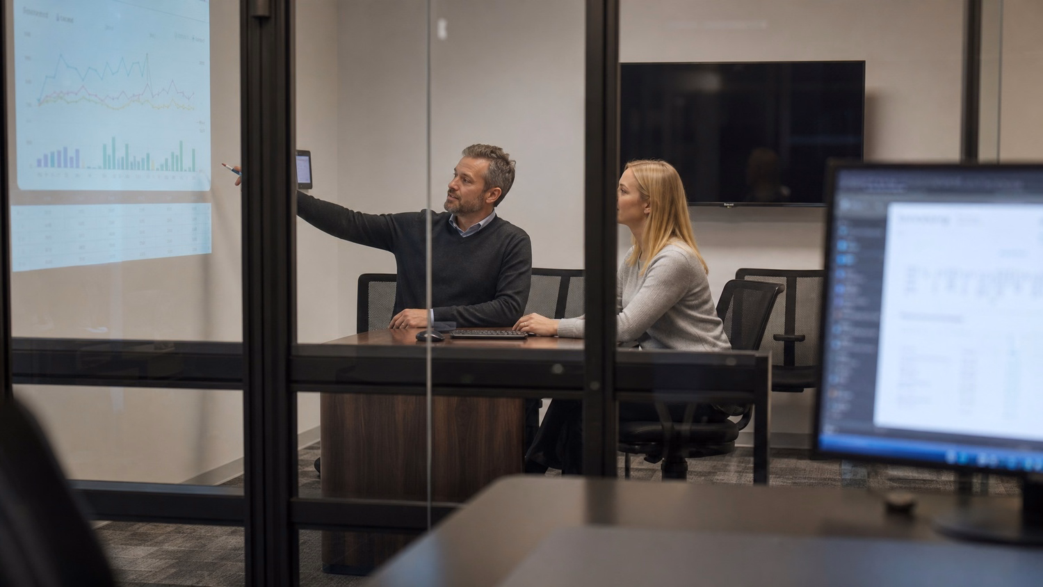Man and woman analyze fluctuating cloud cost report