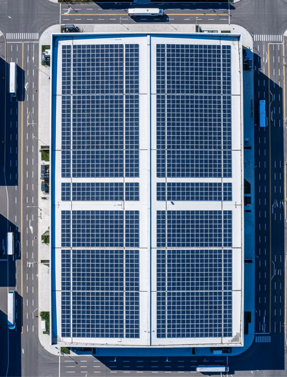Aerial view of a Washington DC warehouse rooftop covered with a Community Renewable Energy (CRE) solar array leased through the District’s commercial rooftop solar program.